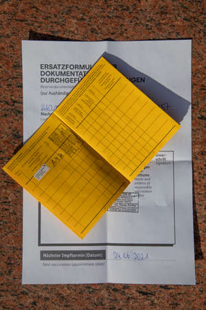 Frankfurt, Germany - April 1, 2021: german vaccination book with documented comirnaty vaccination.のeditorial素材