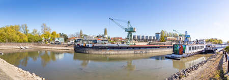 Ingelheim, Germany - April 26, 2021: ship wharf in Ingelheim at river Rhine with crane and pier.のeditorial素材