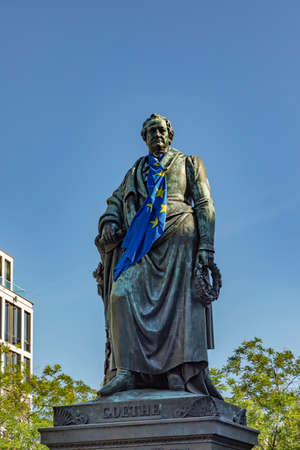 Frankfurt, Germany - June 13, 2021: Statue of Johann Wolfgang von Goethe in Frankfurt am Main with flag of european union.のeditorial素材