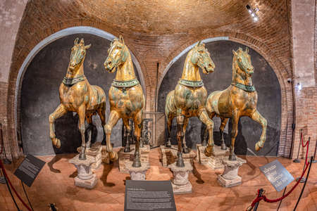Venice, Italy - July 1, 2021: Ancient bronze horses inside the Basilica di San Marco in Venice. Famous quadriga from Constantinople. San Marco or St Mark's Basilica is the main landmark of Venice.のeditorial素材
