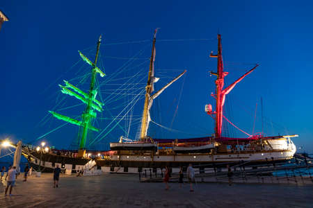 Venice, Italy - July 7, 2021: the italian navy ship Palinuro anchors at the pier of Venice at arsenal area at the day, the G20 summit takes place in this area. The ship is illuminated with Italian flag colors.のeditorial素材