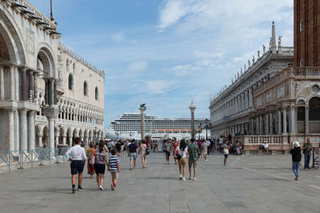 Venice, Italy - July 3, 2021: Cruise ship MSC ORCHESTRA in the Venetian lagoon with gondolas and tourists in the foreground in Venice. Venice is a major tourist destination in Italy.のeditorial素材