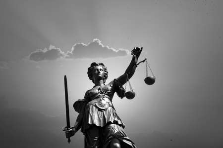 Lady justice at the Roemer in Frankfurt am Main symbolizes Justice with sword and scales in sunset.の写真素材