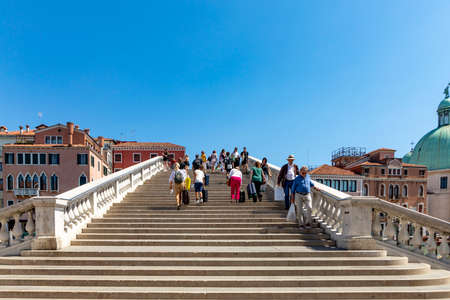 Venice, Italy - July 2, 2021: people crossing grand canal at ponte degli scalzi near luca railway station in Venice, Italy.のeditorial素材