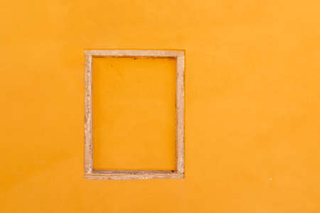 old window frame in venice with orange plaster filling at a historic house wall in Venice