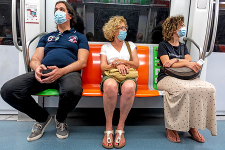 Rome, Italy - August 1, 2021: people in the Metro protect themselves by wearing a medical mask in Rome, Italy.のeditorial素材