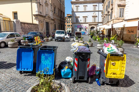 Rome, Italy - August 3, 2021: garbage cans separatet in yellow, reusable, blue - paper and gray - household - in the quarter of Trastevere in Rome, Italy.のeditorial素材