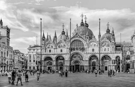 Venice, Italy - July 5, 2021: people watch the sunset at St. Mark's square with view to the basilica di San Marco.のeditorial素材