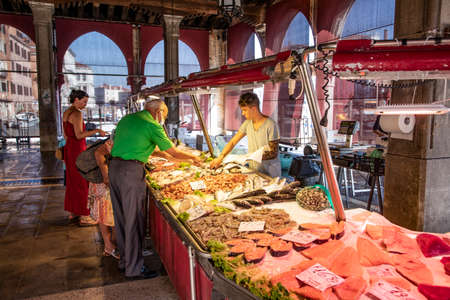 Local people visit the old fish market at Rialto bridge in Venice, Italyのeditorial素材