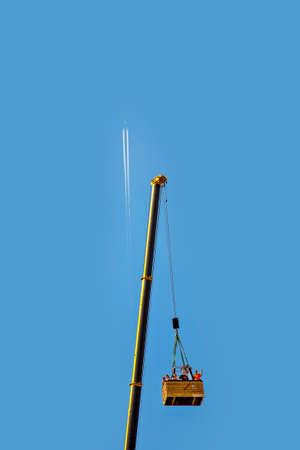 Frankfurt, Germany - August 23, 2009: condensation trail on blue sky, people are happy in a ballon...