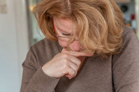 woman with red hair is reading newspaperの写真素材