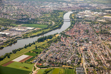 scenic aerial of Kelsterbach and Raunheim after takeoff with river Main, Hesse, Germany