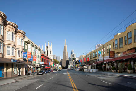 San Francisco, USA - May 18, 2022: old houses in downtown San Francisco in bright light with view to transamerica pyramid.のeditorial素材