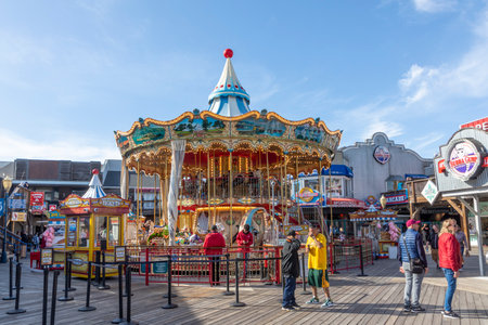 San Francisco, USA - June 7, 2022: Tourists and locals enjoy the riverfront at Pier 39 with restaurants, shops and other touristic facilities.のeditorial素材