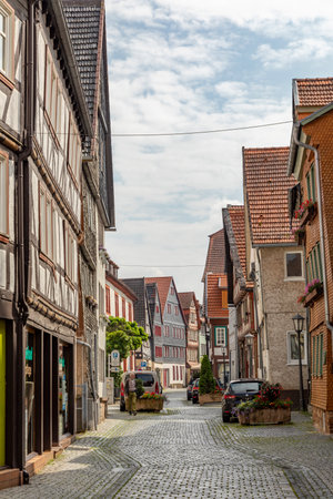 Alsfeld, Germany - June 25, 2021: small historic road covered with cobble stones and half timbered...
