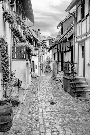 Eguisheim, France - October 4, 2021: scenic small road with half timbered houses in the historic village of Eguisheim in the Alsace region in Franceのeditorial素材