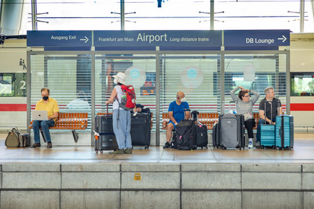 Frankfurt, Germany - May 13, 2022: people at the train station in the airport waiting for the train.のeditorial素材