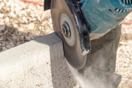 man with a cutting flex cuts a concrete curbの写真素材