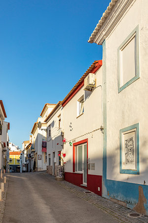 Lagos, Portugal - March 10, 2020: narrow road in old town of Lagos with colorful small historic fishermens houses.のeditorial素材