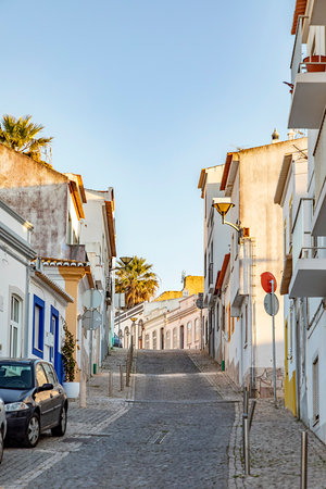 Lagos, Portugal - March 10, 2020: narrow road in old town of Lagos with colorful small historic...