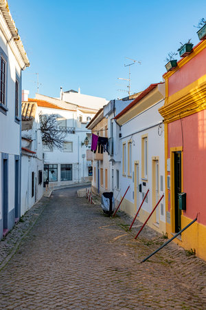 Lagos, Portugal - March 10, 2020: narrow road in old town of Lagos with colorful small historic fishermens houses.のeditorial素材