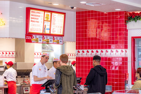 Daly City, USA - April 30, 2019: People enjoy burger at a fast food restaurant In-n-Out Burger.