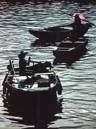 Aberdeen, Hong Kong - November 17, 2009: Boat people in Hong Kong in Aberdeen with umbrella for sun protectionのeditorial素材