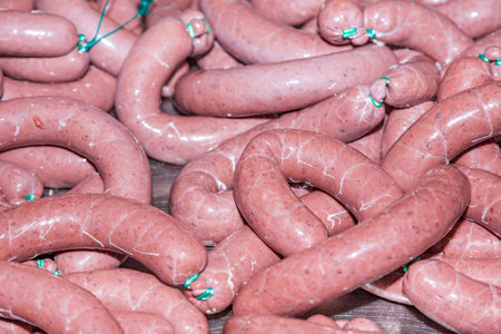 freshly cooked german sausage at the slaughter house drying in the airの写真素材
