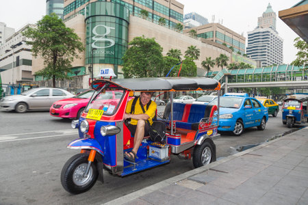 Bangkok, Thailand - May 11, 2009: male tourist in a three weel taxi called bemo poses for a souvenir photo.in Bangkok.のeditorial素材