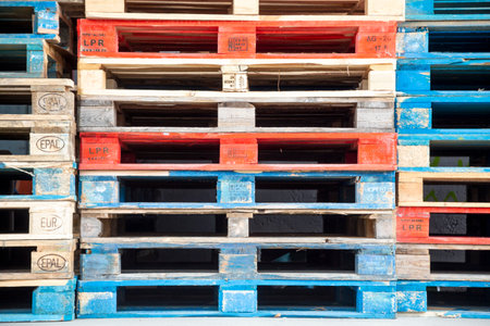 Frankfurt, Germany - January 29, 2022: pallets of european standard configuration stapled and partly marked with blue or red paint.のeditorial素材