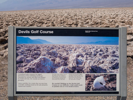 Death valley, USA - July 19, 2008: information sign in the death valley showing and explaining devils golf course, USA.のeditorial素材