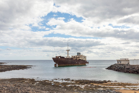 Old rusty sunken ship wreck in the harbor of Arrecife in Lanzarote, Spain