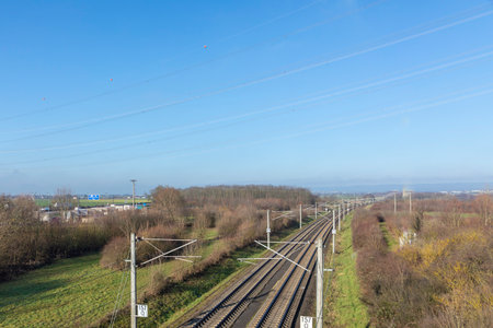 Rails with electrification for high-speed train in Germany under blue sky