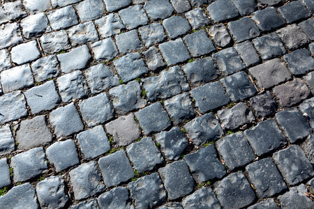 pattern of old historic cobble stones at the street in harmonic light