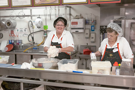 Hurricane, USA - July 17, 2008: employees in a supermarket preparing dough for bread and sweets and enjoy the work.のeditorial素材