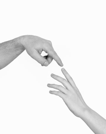 Male and female hands touching each other by index fingerの写真素材