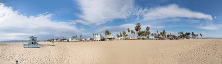 Venice, USA - March 5, 2019:people enjoy scenic beach promenade with palms and colorful houses at Venice Beach in California.のeditorial素材