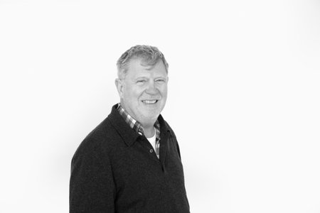 portrait of smiling positive looking senior man isolated on white