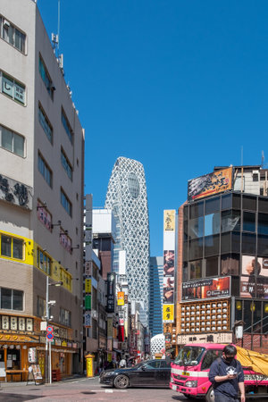 Tokyo, Japan - March 19, 2023: Street view of Nishi Shinjuku Shopping street whith several Japanese restaurants on the sides. Mode Gakuen Cocoon Tower is at the background.のeditorial素材