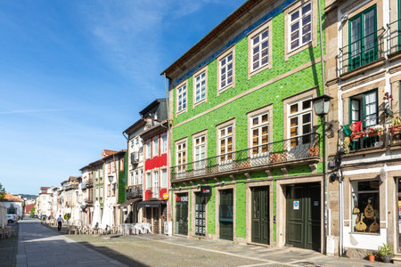 Braga, Portugal - May 1, 2023:street scene in the old town of Braga with historic facades and people...