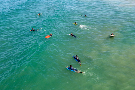Los Angeles, USA - June 25, 2012: people at Redondo beach wait in the ocean for the next wave for surfing.のeditorial素材