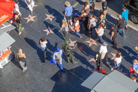 Los Angeles, USA - June 24, 2012: tourists enjoy walking at the walk of fame, the hollywood boulevard, looking for the foot and handprints and of the stars at the sidewalk.のeditorial素材