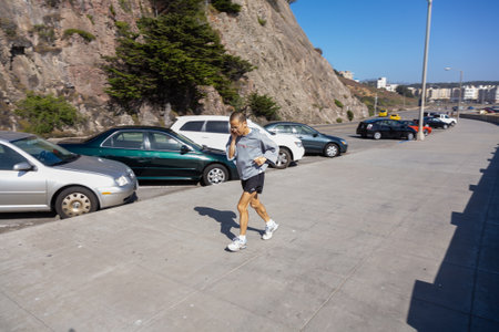 San Francisco, USA - July 23, 2008: jogger enjoys the fresh air at the beach of San Francisco with...