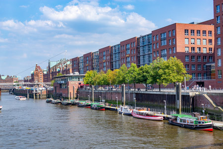 Hamburg, Germany - July 25, 2012: old brick Speicherstadt in Hamburg harbor with pier of ship in...