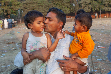 New Delhi, India - November 10, 2011: proud father poses with his children Delhi, India. In 1952, India launches a mass media campaign to spread the concept of family planning to reduce population growth.のeditorial素材