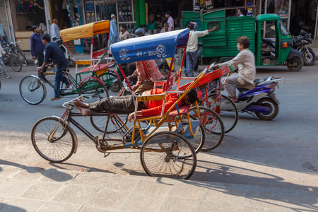 New Delhi, India - November 17, 2011: rickshaw driver at Meena Bazaar in Chandni Chowk is sleeping and takes a rest.のeditorial素材