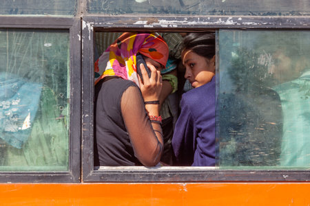 New Delhi, India - November 12, 2011: indian women in a bus using the mobile and talking.のeditorial素材