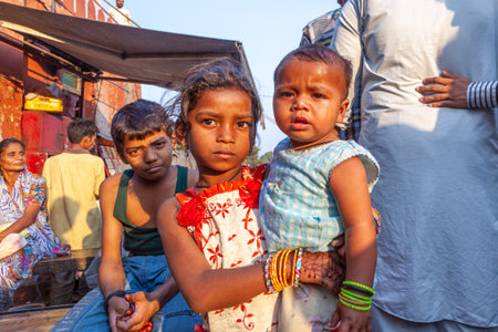 New Delhi, India - November 10, 2011: Portrait of young woman with child on arm at Meena Bazaar...