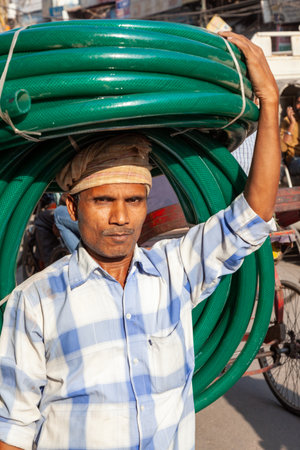 New Delhi, India - November 17, 2011: streetlife at oldest market Chandni Chowk in old Delhi. People carrying goodson their head at Meena Bazaar in Chandni Chowk.のeditorial素材