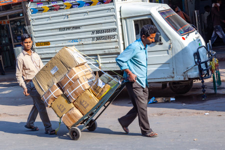 New Delhi, India - November 17, 2011: streetlife at oldest market Chandni Chowk in old Delhi. People carrying goods, sell goods and carrying goods at Meena Bazaar in Chandni Chowkのeditorial素材